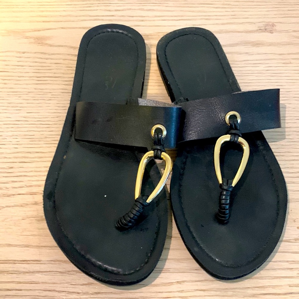 Black sandals with gold hardware